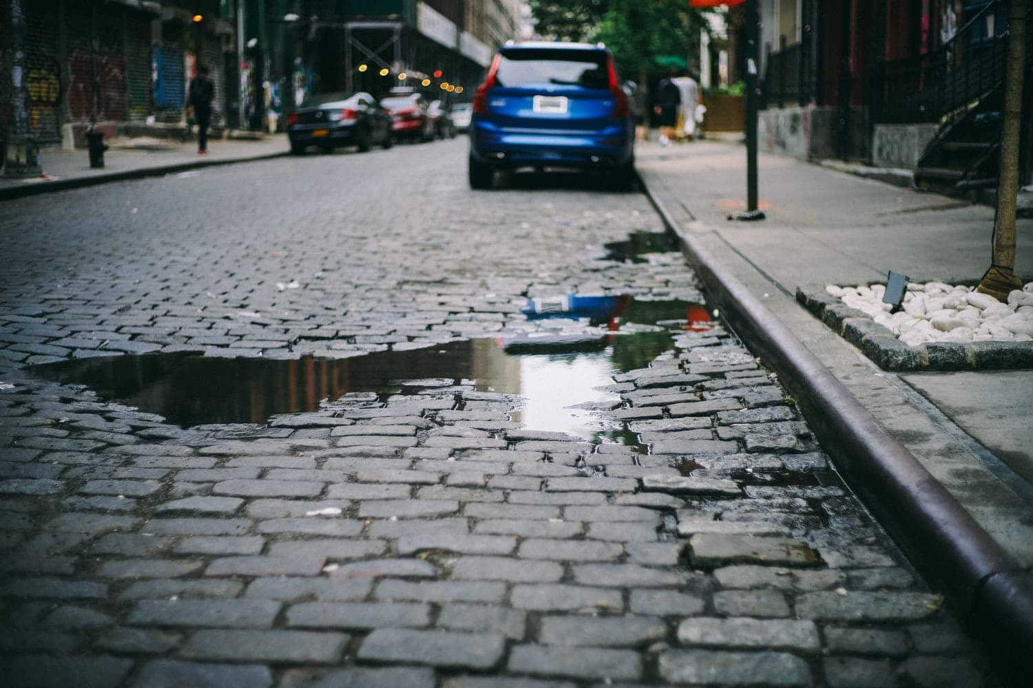 A pothole on a cobblestone road