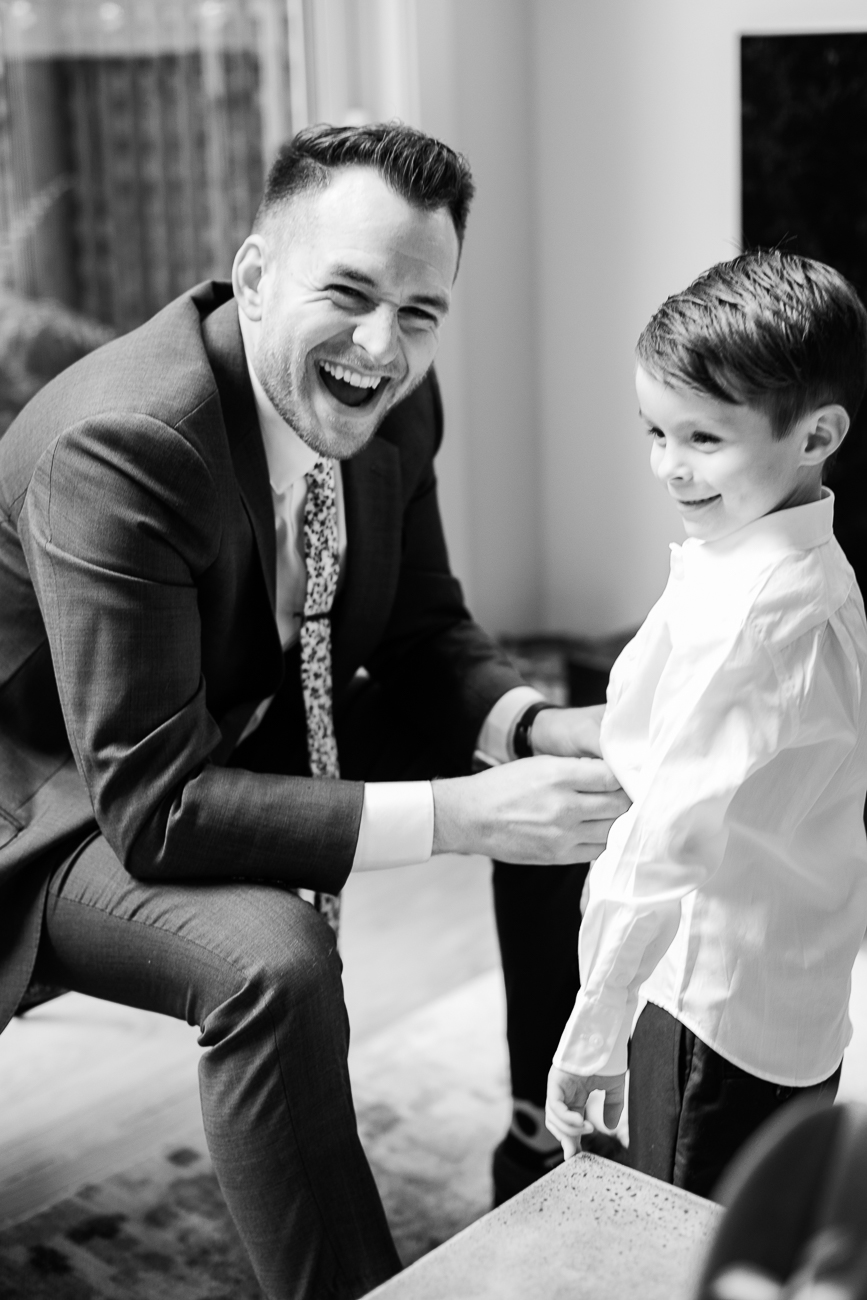 a groom and his son smiling