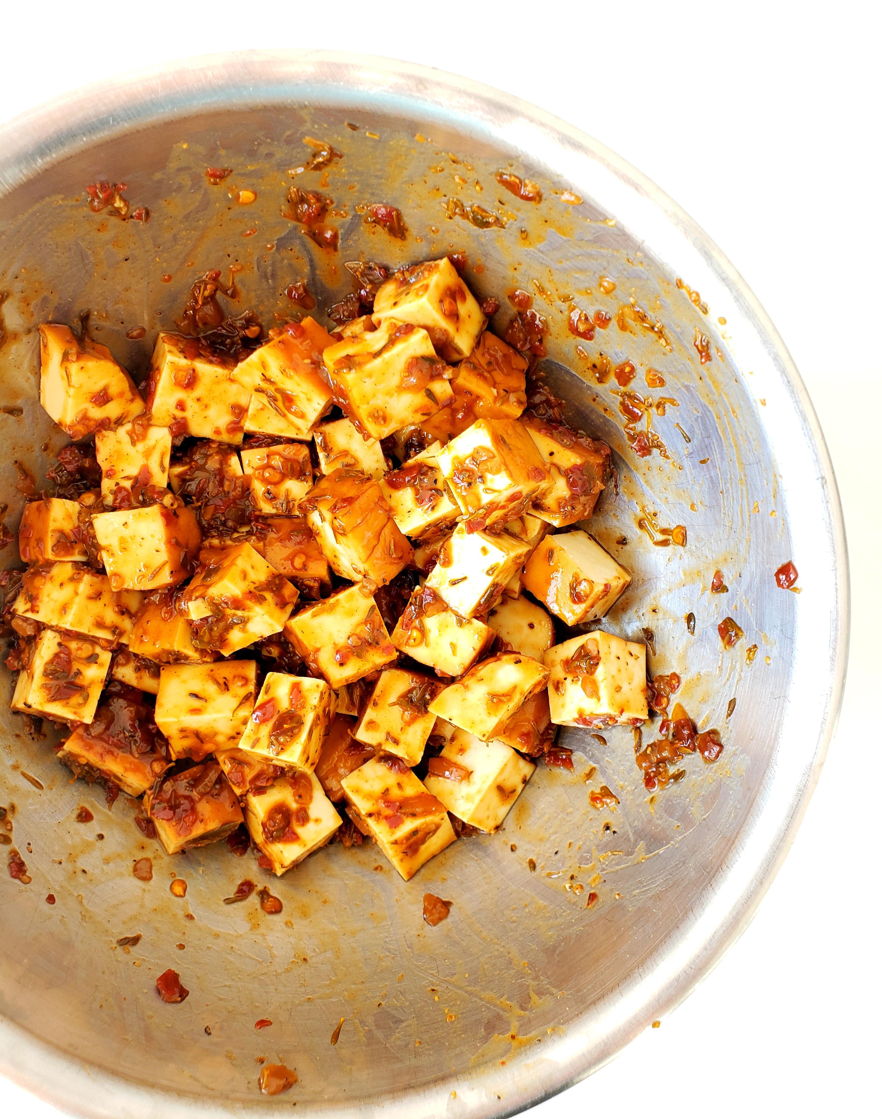 Bowl of Cubed Tofu Tossed in Jerk Sauce