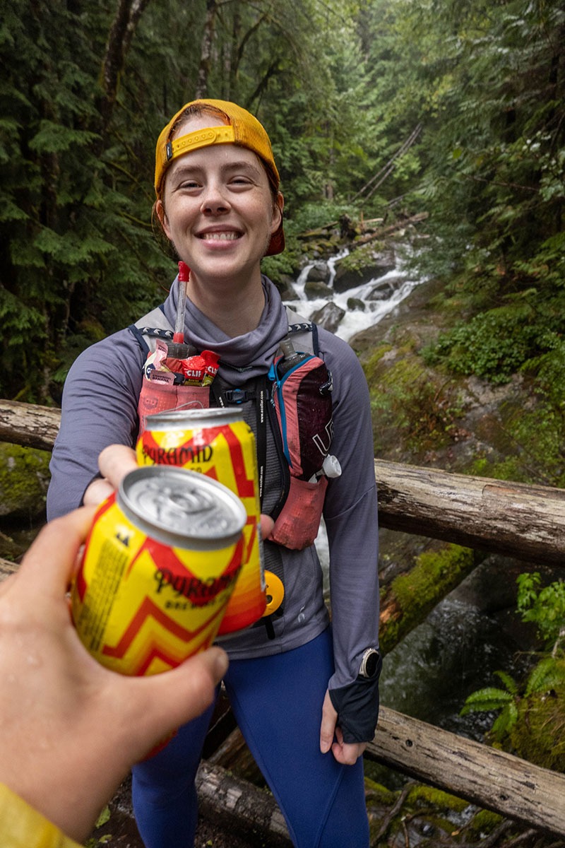 Kaelee Butner cheers photo with Pyramid Brewing in nature after trail running
