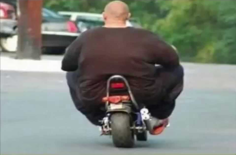 Very overweight man riding a very small motorbike