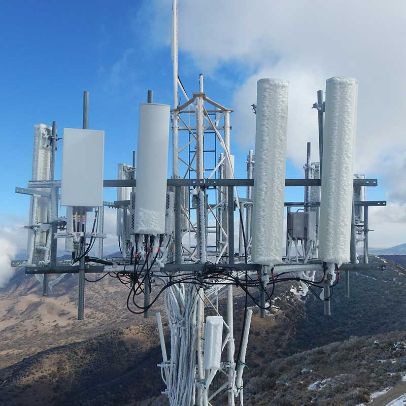 equipment on top of communications tower covered in ice