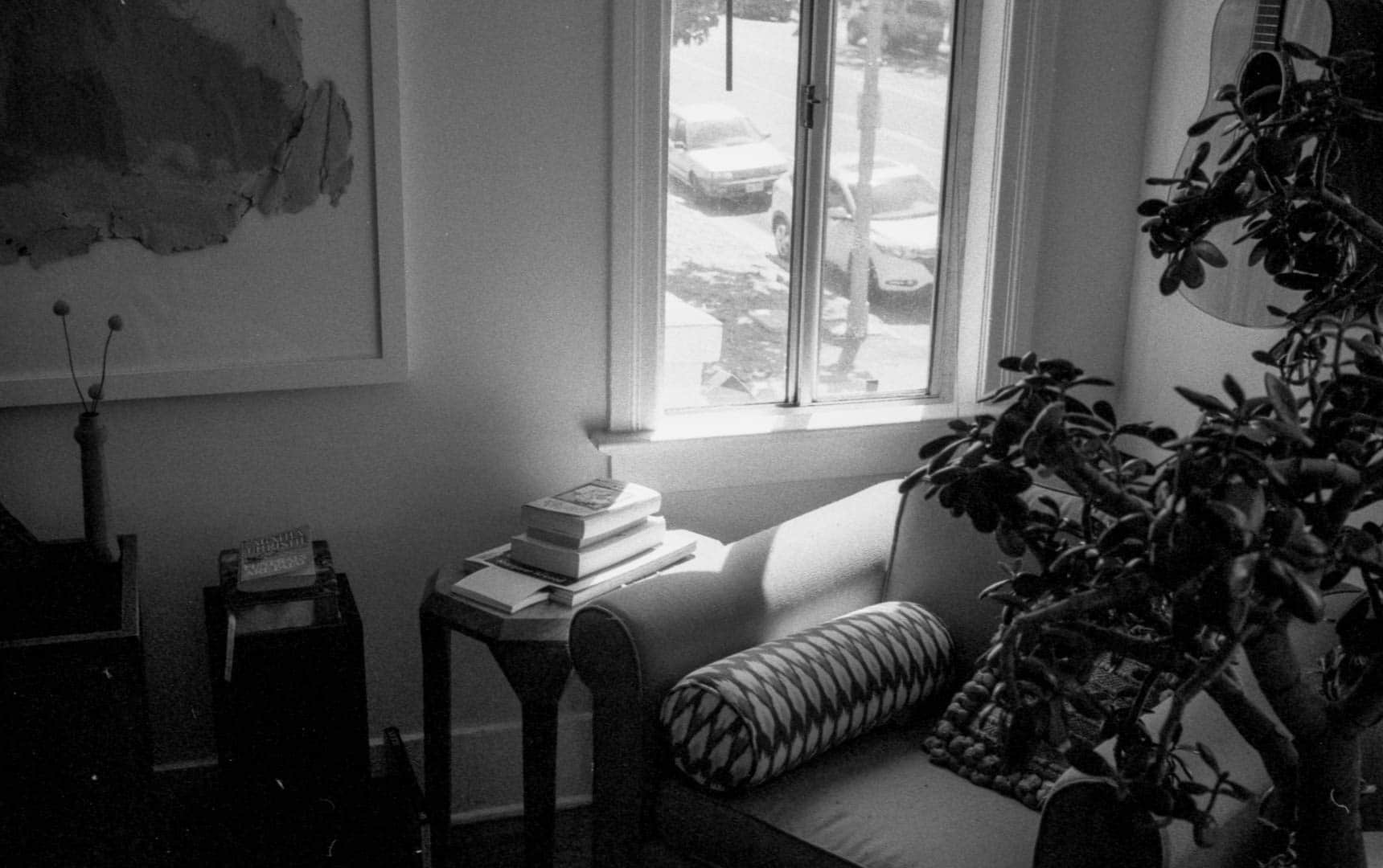 A still life with an upholstered chair in a living room