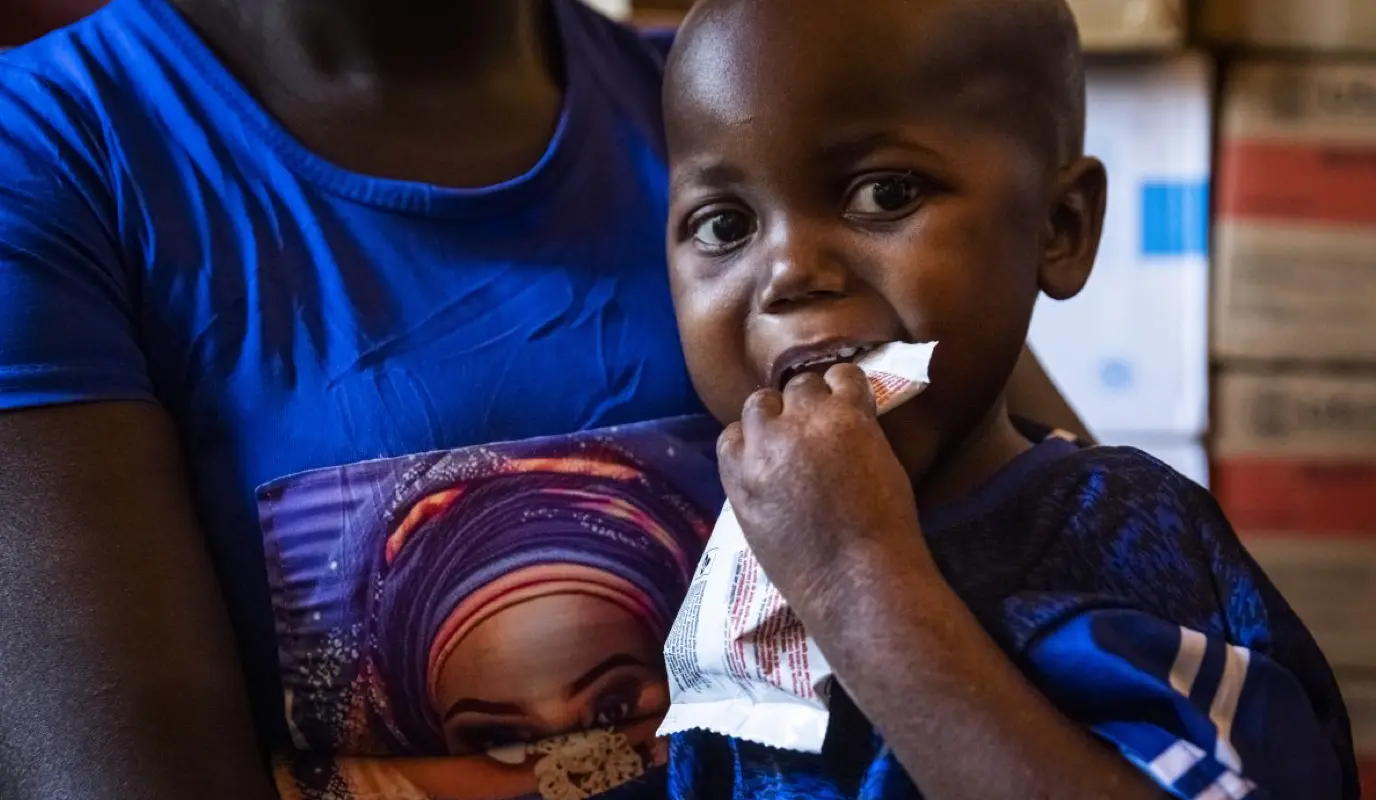 A baby eats some Plumpy'Nut at Yaloké Secondary Hospital in Central African Republic