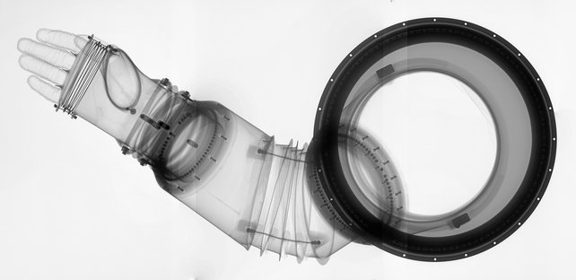 an x-ray of the arm section of a spacesuit, detailing the accordion joint around the elbow and the pipe-like sockets that join it to the shoulder