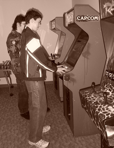 ANO members playing Arcade machines in monochrome.
