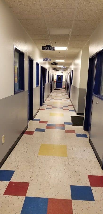 enlarged photo of long hallways of a grey and white painted wall