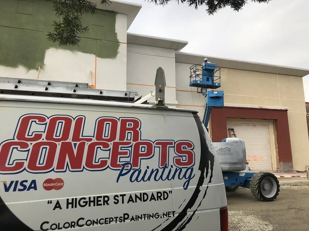 enlarged photo of color concepts branded van parked in front of a large commercial building being painted