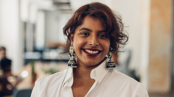Smiling professional woman with fancy earrings