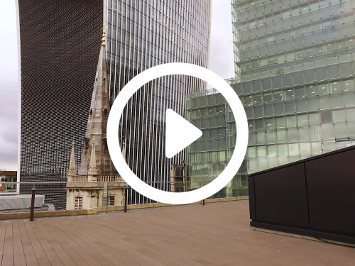 Modern roof terrace with wooden decking holding skyline views on to contemporary and artistically designed offices Zoom background