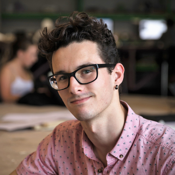Griffen smiling at the camera in The University of Sydney Homebase studio