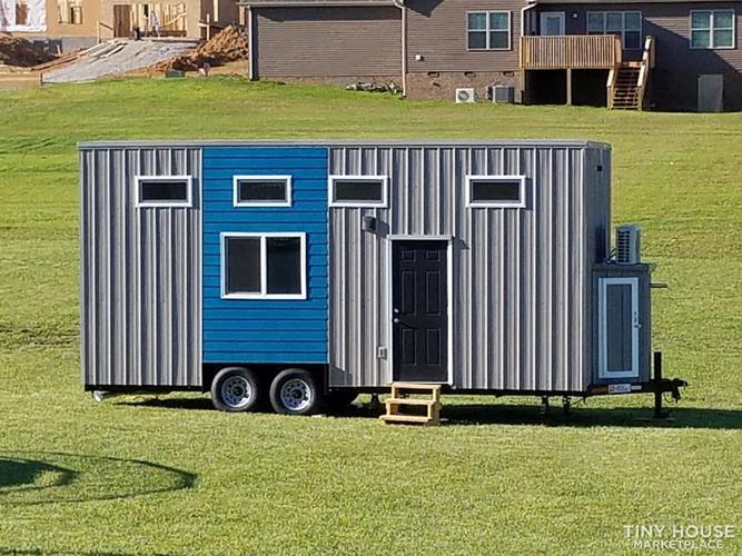 External photo of the Jefferson-based tiny home on wheels, with 5 windows and a solid front door. External photo of the Jefferson-based tiny home on wheels, with 5 windows and a solid front door.