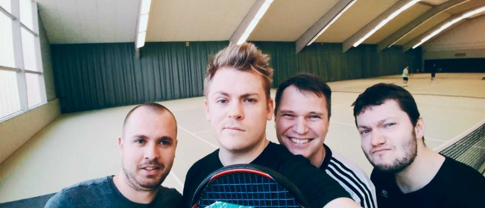 happy and a bit silly posing of the rentware team at an indoor tennis court