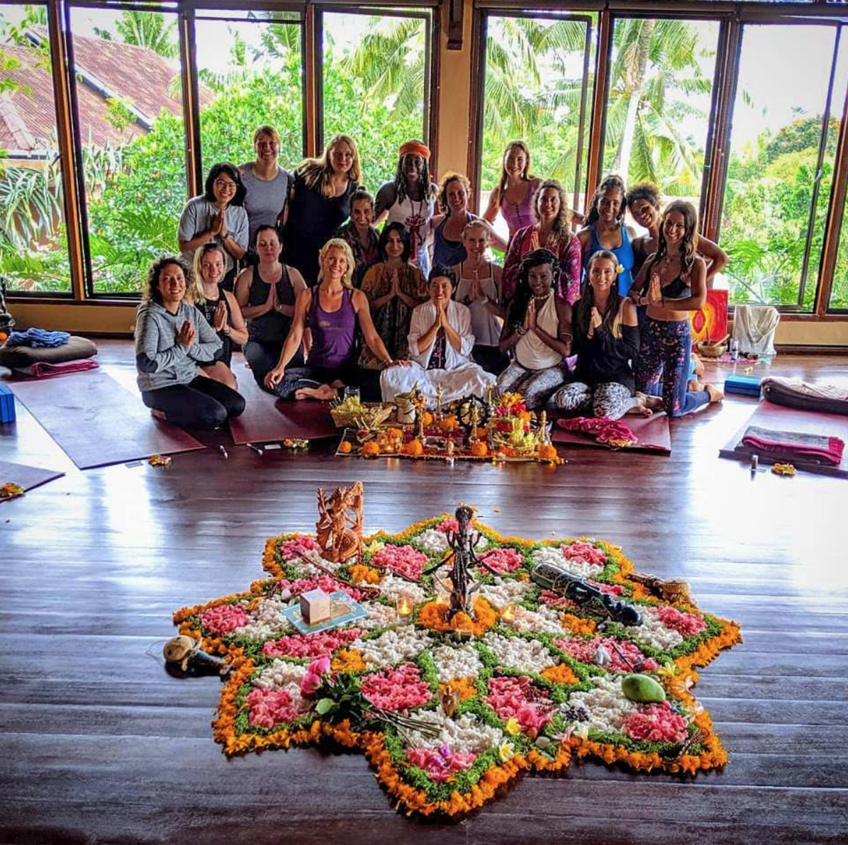 Bali priestess giving blessings at yoga barn retreat