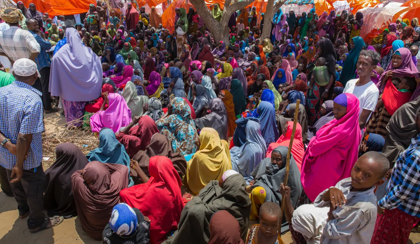 Displaced families collect SIM cards for emergency cash phone transfers from Concern Worldwide at a displacement camp in Mogadishu, Somalia