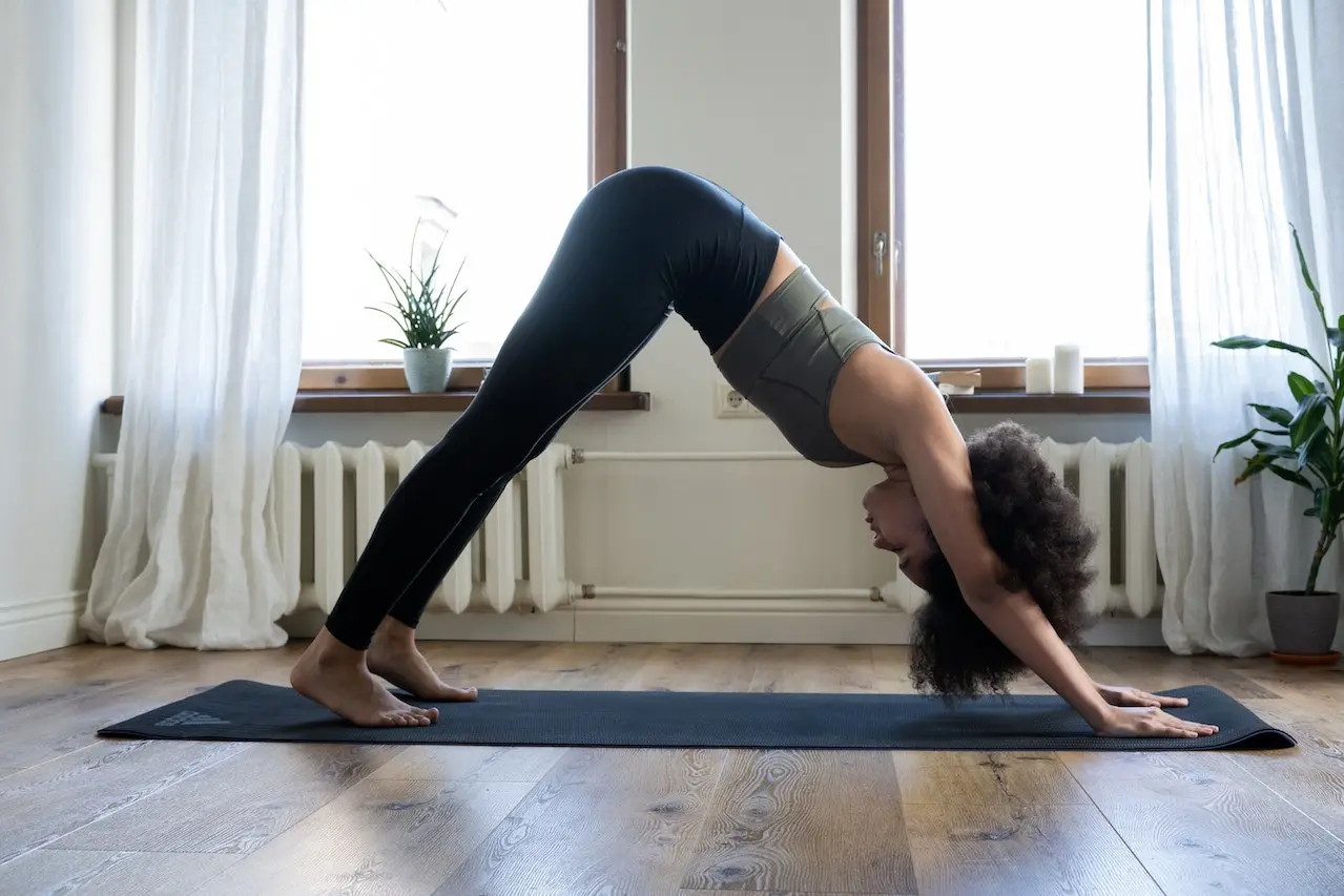 Woman in standing forward yoga pose