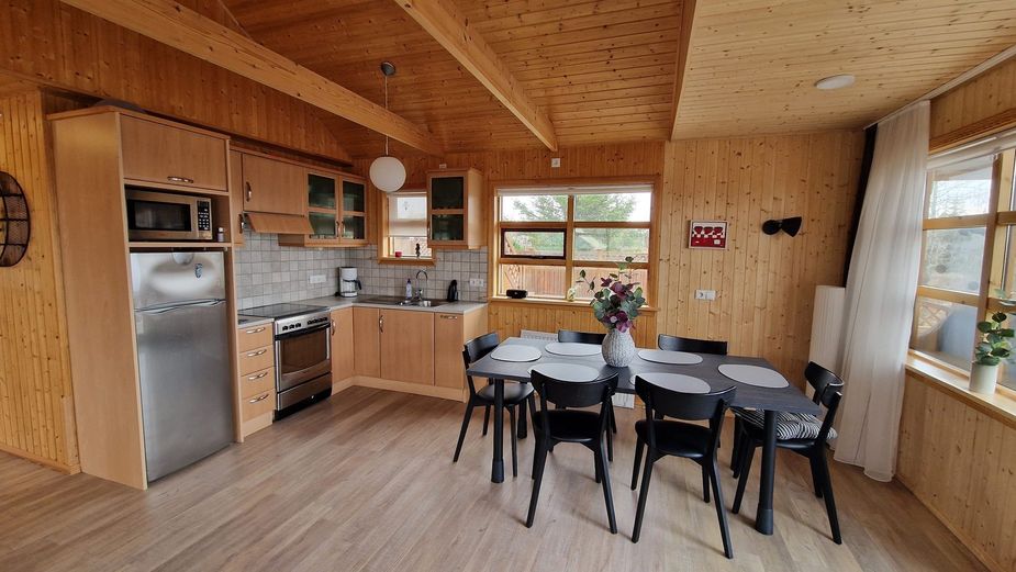 Kitchen with large fridge and dining table for 6 people