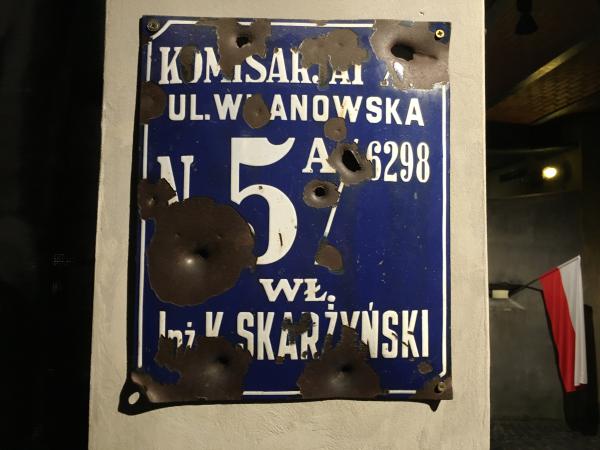 Bulletholes on a real street sign from Warsaw WWII