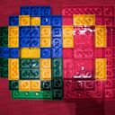 A mosaic of Duplo bricks in a few colours. The yellow bricks make the digital strokes of an eight and a seven.