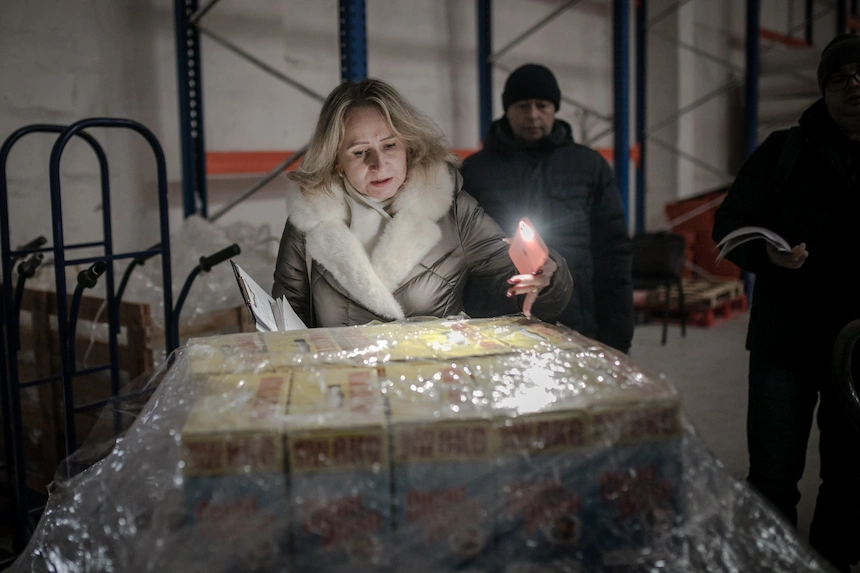 Woman inspecting humanitarian aid supplies to Ukraine