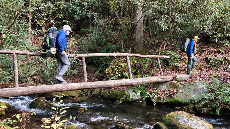 Crossing a footbridge over Lost Cove Creek