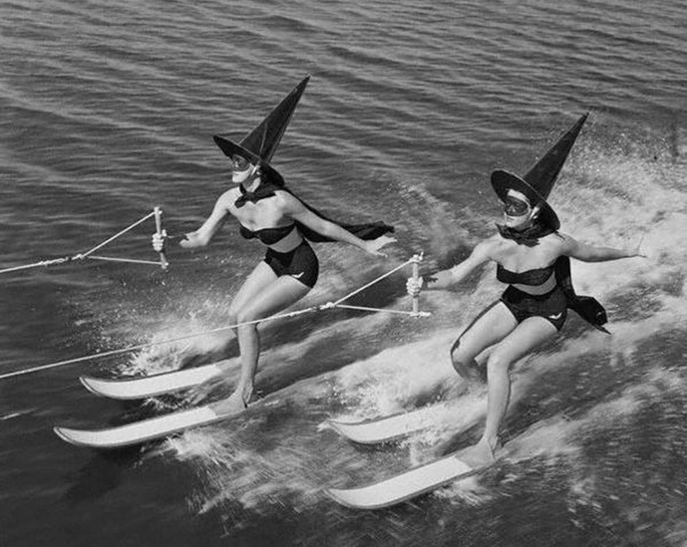 women dressed as witches on water skis