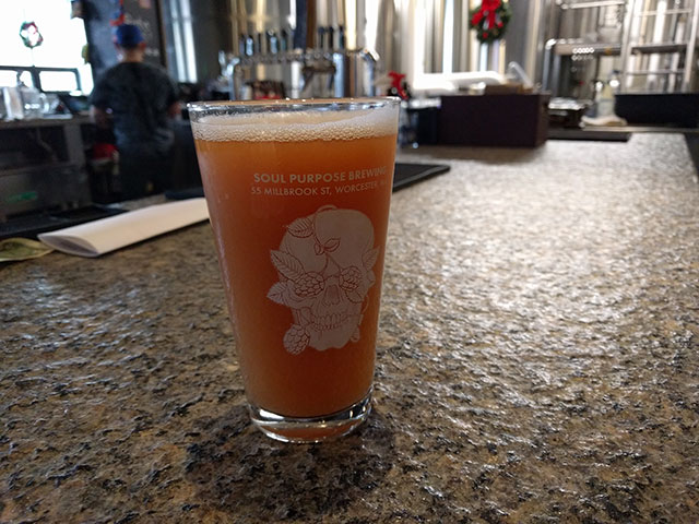 A pint glass filled with craft beer from Massachusetts
