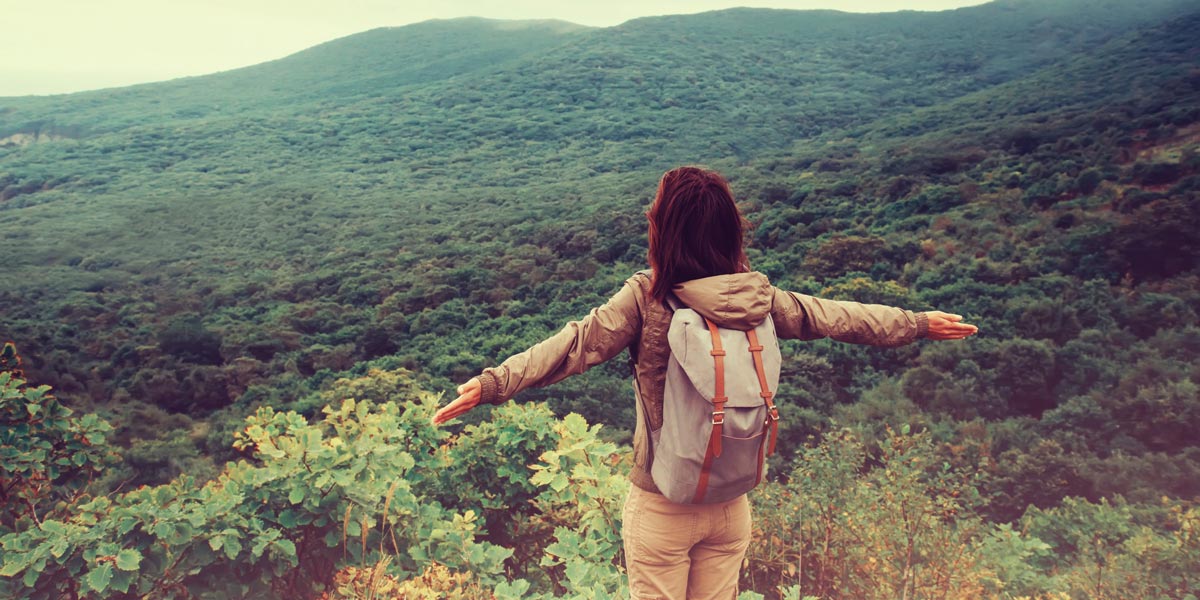 A digital nomad looking at a scenic view A digital nomad looking out over a scenic mountain view