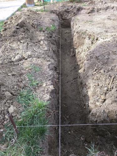 Initial trench being dug, with string lines to guide where the trenches need to go. Initial trench being dug, with string lines to guide where the trenches need to go.