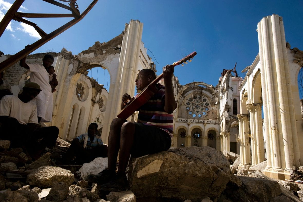 Olince Calixte plays guitar in the ruins of Port au Prince’s Notre Dame Cathedral