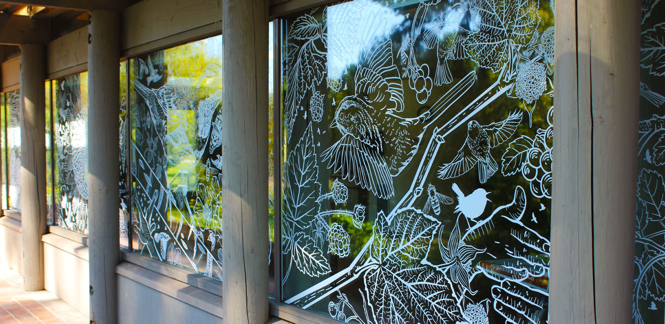 Windows at the UBC Botanical Gardens, which have been covered in artistic decals to prevent birds from flying into them