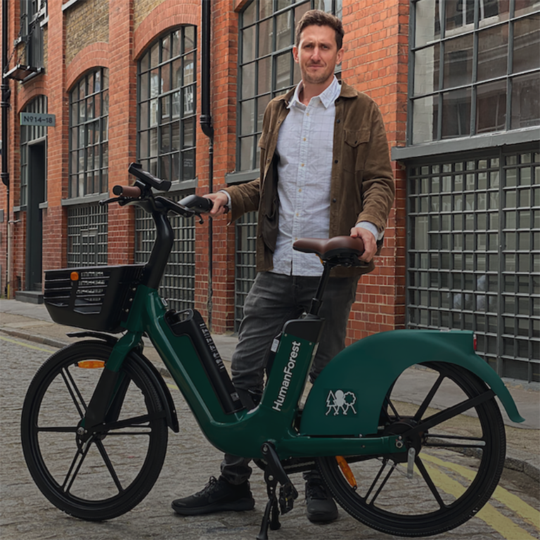 Agustin Guilisasti standing with the HumanForest e-bike in the middle of a street in London.