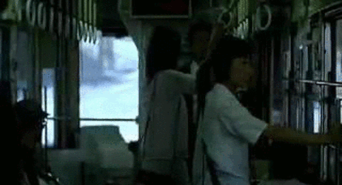 An animated gif of Yoko riding the bus while standing. A scene from the movie 'Cafe Lumiere'.