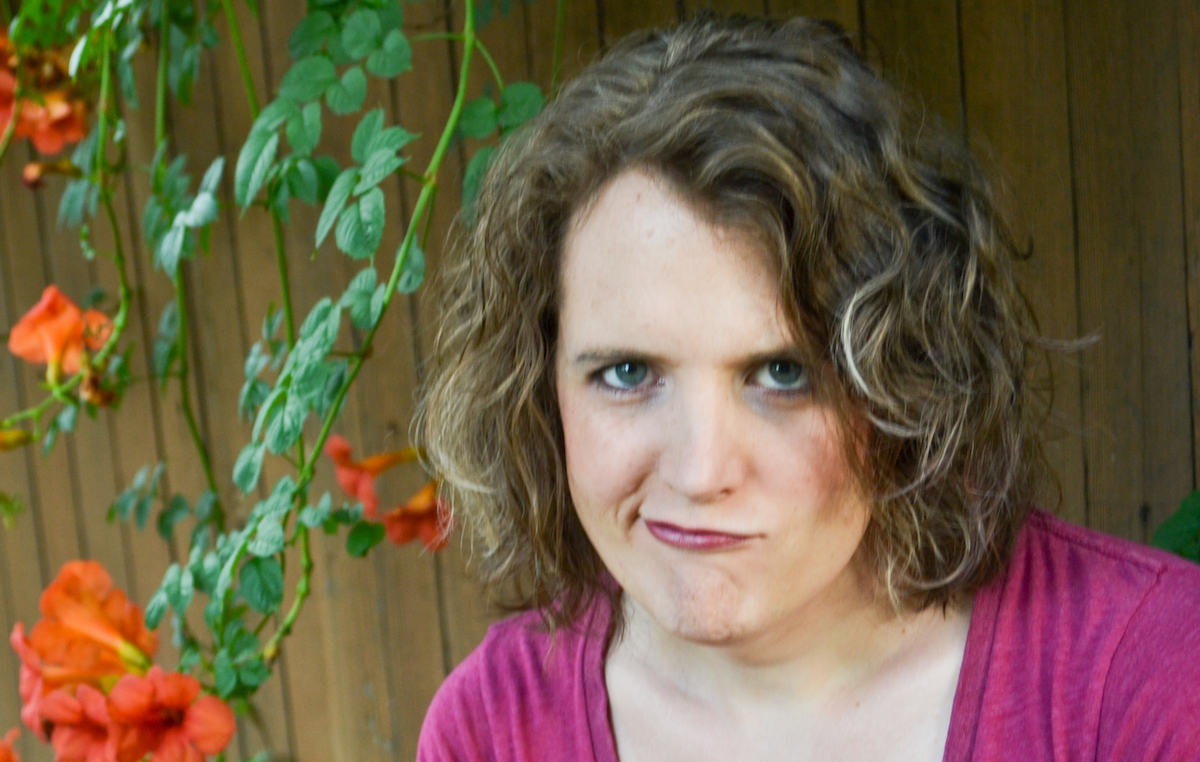 Headshot of Mia smirking