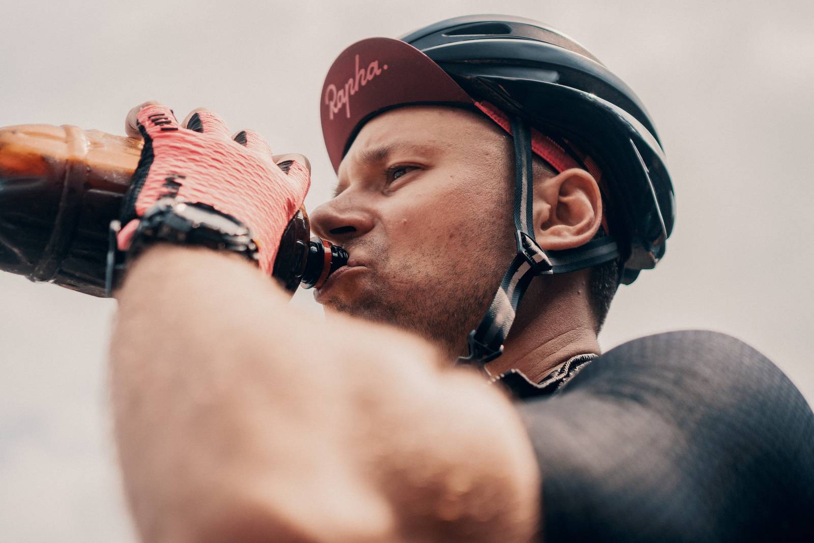 Photo of cyclist drinking from a water bottle by Viktor Bystrov via Unsplash