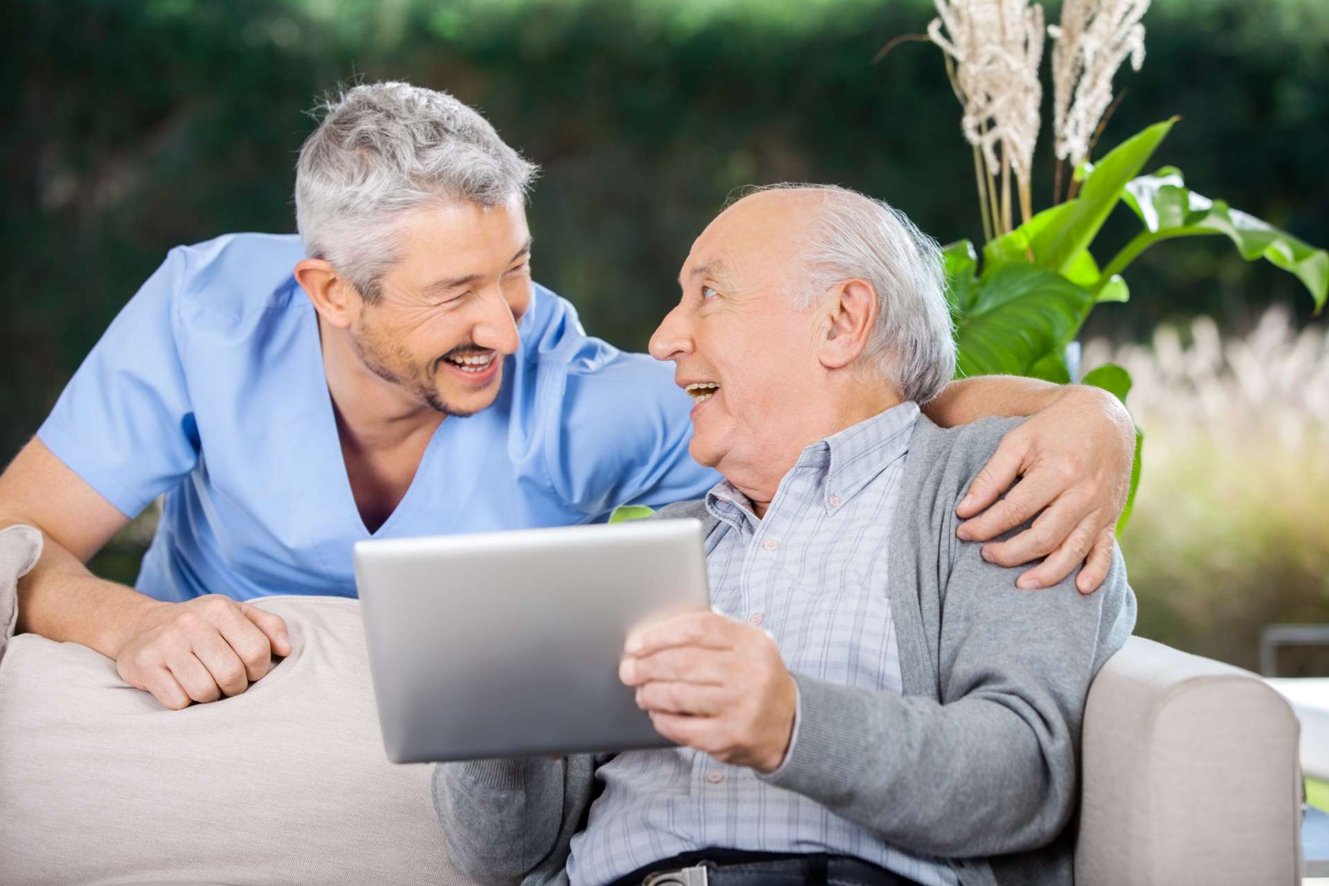 elderly man with caregiver on CaseKeepers creating caregiver logs