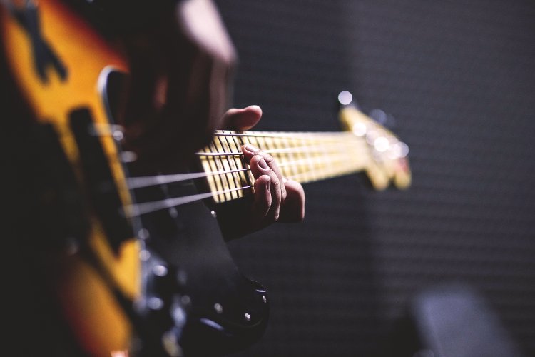 Man playing bass - Photo by freestocks.org on Unsplash