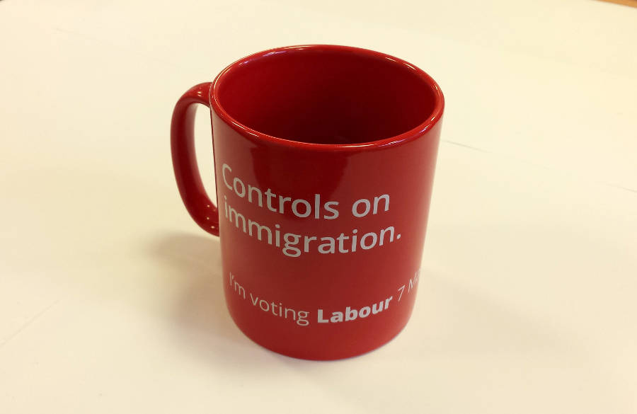 A red mug with the words Controls on Immigration printed on it