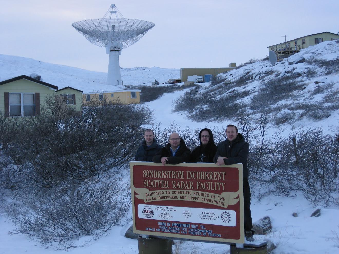Sondrestrom staff standing before Sondrestrom radar dish in background.