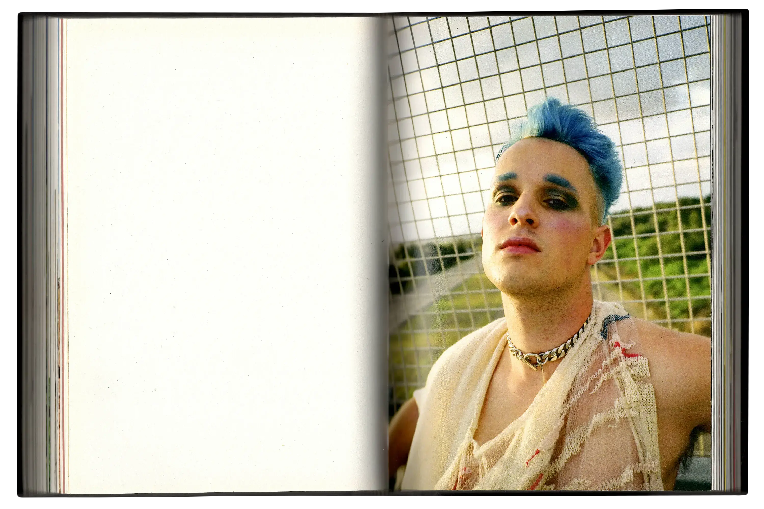 Imperfect Photo Book - left page blank, right page shows person with blue hair posing with draped fabric over their shoulders