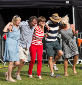 Lingfest 2019 three women and two men in a line arms around each others sholders doing slightly tipsy line dancing ©Brett Butler