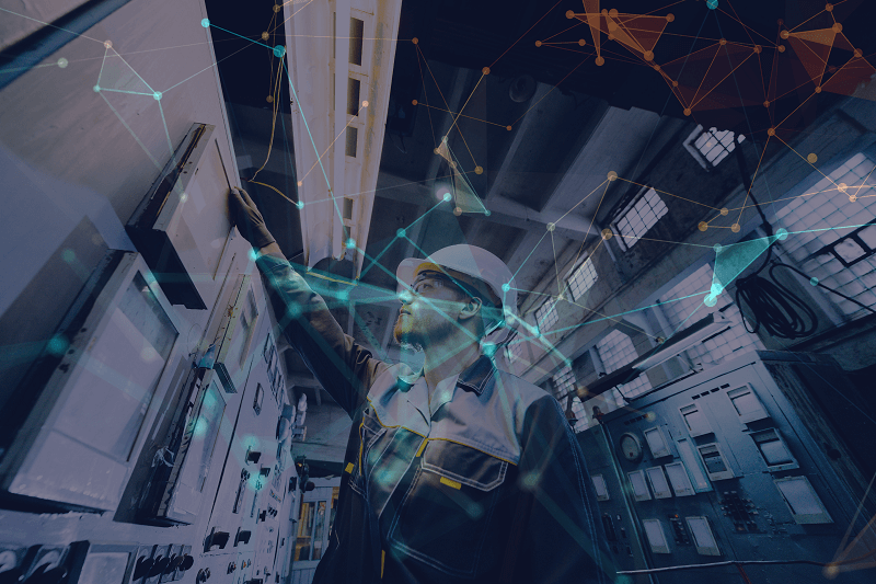 An employee working with digital systems in a manufacturing environment.