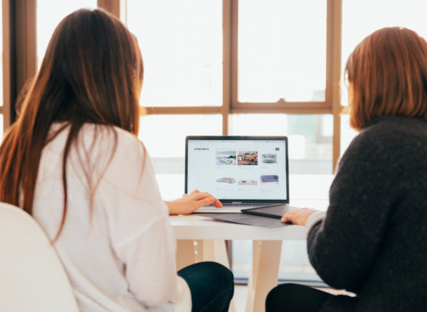 Two woman looking at a laptop