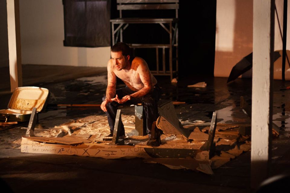 Man sitting in the rubble of drywall