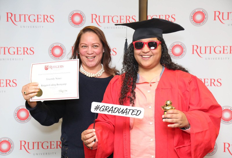 Rutgers boot camp graduate in their cap and gown
