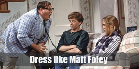 Matt Foley usually wears a light blue blazer, a green tie, and khaki pants