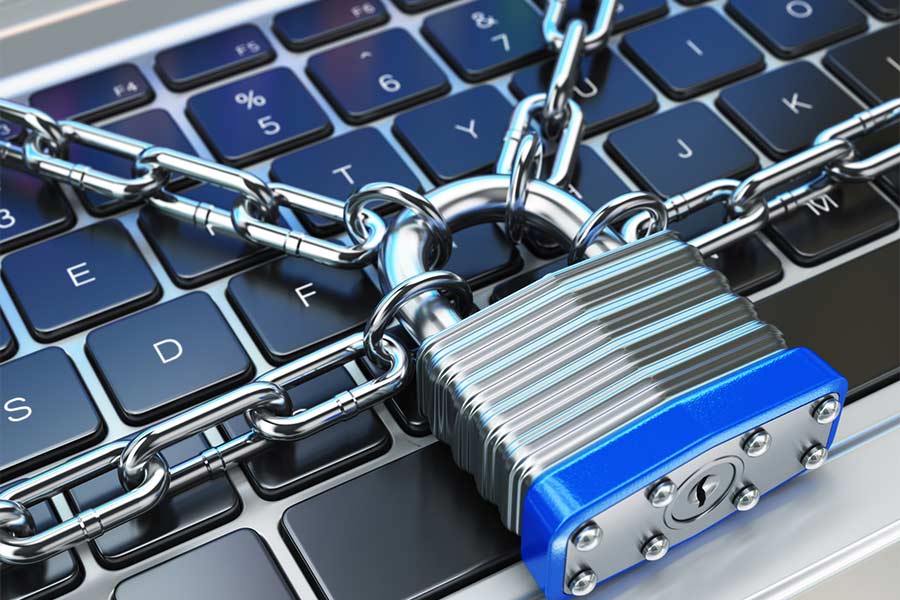 A padlock and chains securing a laptop keyboard