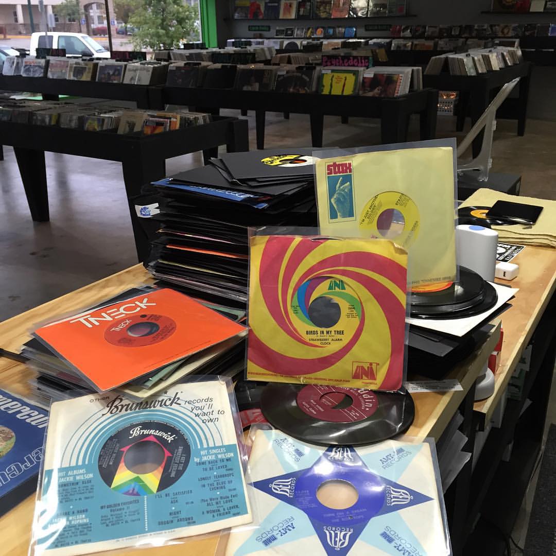 Front counter at Brothers Music stacked with records/vinyl