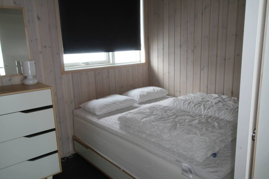 Bedroom with a double bed and blackout curtains