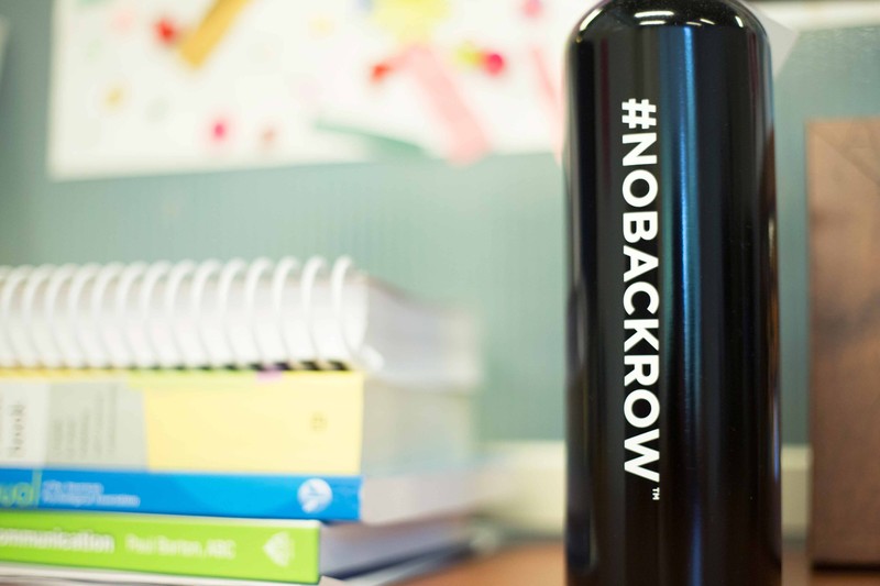 Close up view of a black water bottle with a No Back Row hashtag on it